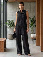 Female model wearing the black sleeveless stand-collar jumpsuit