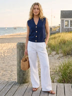 Model in navy knit sweater vest with gold shell buttons
