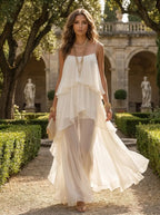 Model wearing sheer tiered chiffon maxi formal gown