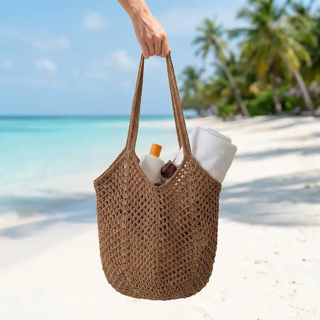 Crochet mesh tote bag carried by a woman in a bright summer setting
