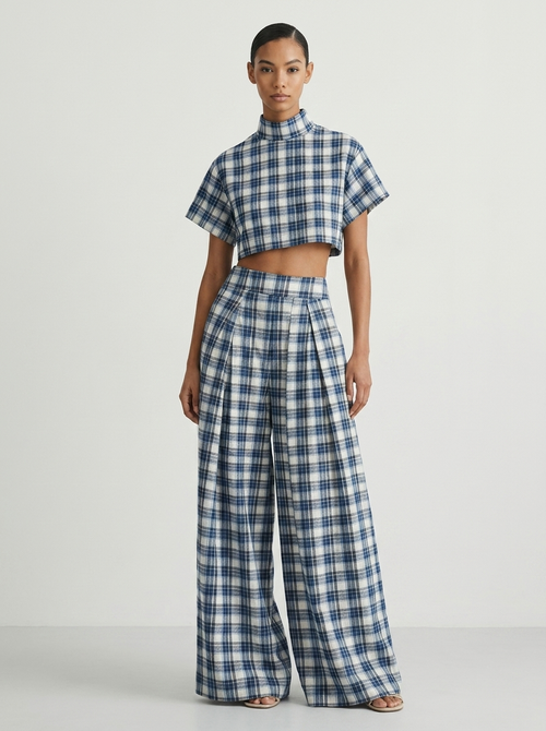 Model wearing blue and white plaid crop top and wide-leg pants set